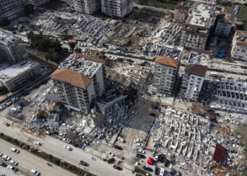epa10452945 A photo taken with a drone shows a an aerial view over collapsed buildings after an earthquake in Hatay, Turkey, 07 February 2023. Thousands of people died and thousands more were injured after major earthquakes struck southern Turkey and northern Syria on 06 February. Authorities fear the death toll will keep climbing as rescuers look for survivors across the region.  EPA/ERDEM SAHIN